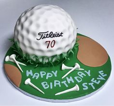 a birthday cake with a golf ball and tees on it