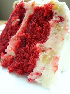 a slice of red velvet cake with white frosting