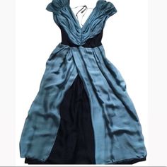 This Alberta Ferretti, Italian Made Cocktail Dress Is Mid-Length With A Beautiful Low Cut Front And Back. The Material Is Silk Chiffon With A Blush Blue Exterior And A Dark Navy Blue Lining. The Dress Is Gently Used, With Small Snags Near The Bottom Of The Dress As Pictured. The Dress Is An Italian Size 38, Usa Size 2. Make An Offer! Underarm To Underarm Approximately 16” Waist Approximately 12” Hips Approximately 21” Length Approximately 46” Invisible Side Zipper Pet Free, Smoke Free Home. Blue Exterior, Chiffon Cocktail Dress, Alberta Ferretti, Dark Navy Blue, Silk Chiffon, Dark Navy, Low Cut, Mid Length, Victorian Dress