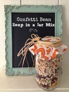 a jar filled with beans sitting on top of a shelf next to a chalkboard