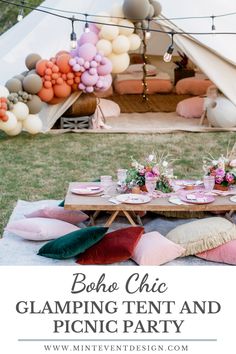 a picnic table set up with balloons and pillows for a boho chic glamping tent and picnic party