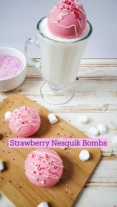 pink frosted donuts with sprinkles and marshmallows on a cutting board