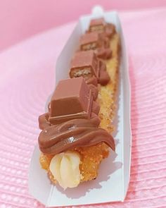 a piece of cake sitting on top of a white plate covered in chocolate and banana slices