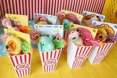 stuffed animals are in popcorn boxes on a table