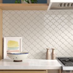 a white bowl sitting on top of a kitchen counter next to a stove and oven