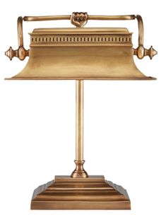 an antique brass desk lamp on a white background with clippings to the side