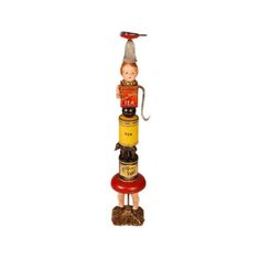 a small figurine sitting on top of a stack of stacked bottles with an umbrella hanging from the top