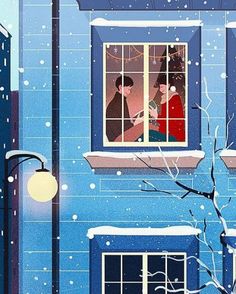 two people are looking out the window on a snowy day in front of a blue building