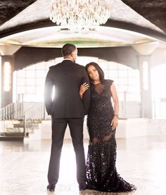 a man in a tuxedo standing next to a woman in a black dress