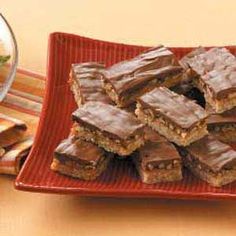 a plate full of brownies sitting on top of a table next to a bowl of salad