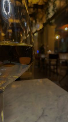 a glass of wine sitting on top of a table