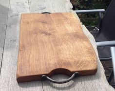 a wooden cutting board sitting on top of a table