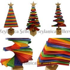 several wooden christmas trees made from colored strips and wood dows with stars on top