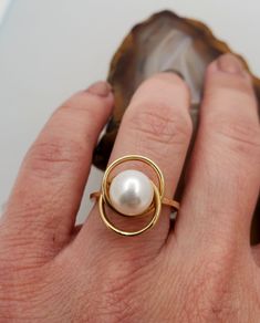 ES2056 Vintage pearl 14k gold ring. 14k yellow gold ring with interlocking circles design set with genuine 8mm white pearl. Hallmark: 14k. Height: 11.8mm. Diameter of circles: 15mmx12mm. Ring size: 6, can be resized, please inquire. This is very fun and playful ring. Modern 14k Gold Pearl Open Ring, Modern 14k Gold Pearl Ring For Wedding, Modern Yellow Gold Pearl Ring For Formal Occasions, Modern Yellow Gold Pearl Ring For Anniversary, Modern 14k Yellow Gold Pearl Ring, Modern Round Pearl Ring In Yellow Gold, Modern Gold Pearl Ring, Modern Oval Pearl Ring For Anniversary, Elegant Gold Oval Bypass Ring