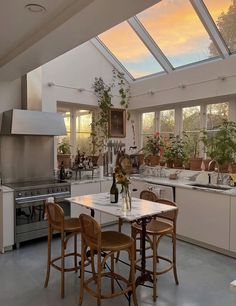 a kitchen filled with lots of counter top space next to a stove top oven and sink