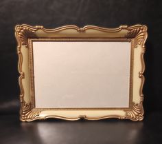 an ornate gold frame on a black surface