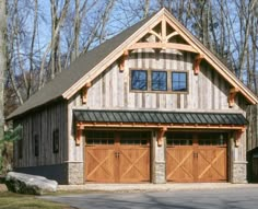 a two car garage in front of a wooded area