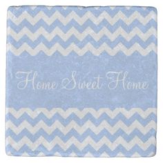 a brown and white chevroned tile with the words home sweet home on it