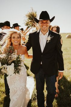 a bride and groom walking down the aisle