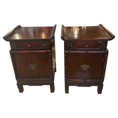 a pair of wooden nightstands sitting next to each other