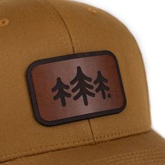 Description: Looking for a stylish and functional trucker hat? Look no further! This hat is made from high-quality materials and features a mesh back for breathability. The TriPine Leather Patch Trucker Hat is also adjustable, so you can find the perfect fit. Each leather patch is unique and may have natural blemishes. Brown Six-panel Outdoor Hats, Breathable Flat Bill Fitted Hat For Outdoor, Brown Six-panel Hat For Outdoor Activities, Adjustable Brown Six-panel Trucker Hat, Breathable Curved Bill Hat For Outdoor, Outdoor Breathable Hat With Curved Bill, Leather Patch Trucker Hat For Camping, Outdoor 5-panel Baseball Cap With Leather Patch, Outdoor Curved Bill Breathable Hat