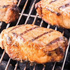 three steaks cooking on the grill with one being grilled