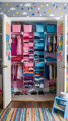 an organized closet with pink and blue bins filled with clothes, toys and other items