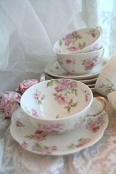 a table topped with plates and cups filled with flowers