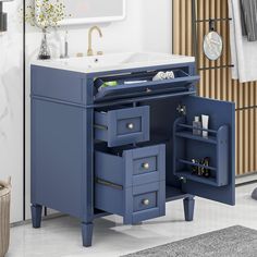 a bathroom vanity with drawers and a sink in the corner, next to a mirror