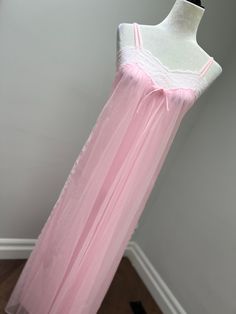 A lovely soft pink chiffon nightgown with delicate white lace on the top and down the sides. Straps are made of the same chiffon fabric, as well as the sweet little bow. Fully lined. Made in Montreal Canada. Pink Delicate Lace Sleepwear, Feminine Sheer Pink Sleepwear, Feminine Pink Sheer Sleepwear, Feminine Pink Sleepwear With Delicate Lace, Pink Sheer Sleepwear For Wedding Night, Pink Lace Sleepwear For Bedtime, Feminine Pink Sleepwear With Lace Trim, Pink Feminine Sleepwear With Lace Trim, Pink Delicate Lace Sleepwear For Spring