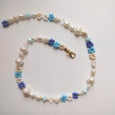 a necklace with pearls and blue beads