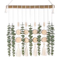 a wall hanging made out of wood and green leaves