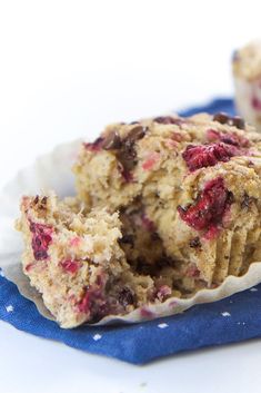 two muffins sitting on top of a blue napkin