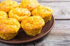 some yellow muffins are on a brown plate