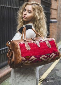 Leather Kilim travel bag, kilim Duffle Bag, Unisex Kilim Weekender Bag, Moroccan Kilim duffel Bag, Leather duffle bag, hipster travel bag Beautiful Leather This handwoven kilim travel bag was made from full-grain leather and old carpet and is perfect for your bohemian wardrobe. This work of art was created with a unique vintage kilim that was upcycled and weaved with vibrantly colored wool by skilled craftspeople in Marrakech, Morocco: 💥💥 Notes Please keep in mind that because the travel bags are made from Red carpet patterns, the design may vary and cannot be made exactly like the picture because it is a handmade product. No two pieces are the same because our products are handmade and each is uniquely crafted. Every product we produce is distinctive and original. Dimension: SMALL: Leng Luxury Bohemian Rectangular Travel Bag, Luxury Bohemian Travel Satchel, Luxury Multicolor Weekender Bag For Travel, Traditional Carpet, Weekend Travel Bags, Unique Travel, Moroccan Kilim, Carpet Bag, Leather Duffle Bag