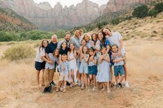 a family poses for a photo in front of the mountains