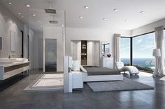 a modern bedroom with large windows overlooking the ocean