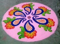 a pink and blue flower design painted on the ground with green leaves, flowers, and dots