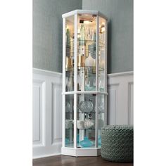 a tall white curio cabinet with glass doors