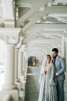 a bride and groom pose for a wedding photo