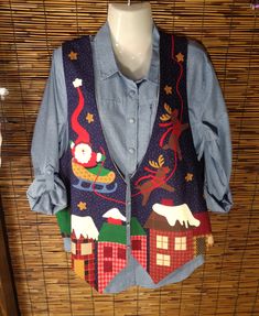 Ready to Ship - Ladies Christmas themed holiday vest. Santa and reindeer on the front. So cute. Open front and generous arm holes allow you to wear a sweater or sweatshirt underneath. Reversible and Fully lined with a blue patterned cotton lining.  Easy wash and wear. Festive with pretty colors. You'll get lots of wear from this vest.  Handmade, new and never worn. I'm always adding more vests with different themes for holidays. So check in often to see what is new. They go fast. Check out all my other vests and items here: https://holidayvestsandbibs.etsy.com Holiday Vest, Vest Handmade, Ladies Shirt, Womens Sleeveless Tops, Pretty Colors, Santa And Reindeer, Handmade Holiday, Vest Outfits, Check In