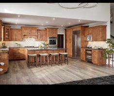 a large kitchen with wooden cabinets and stools