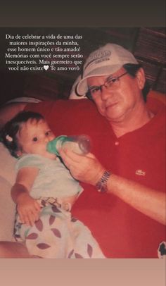 an older man is holding a baby and drinking from a bottle