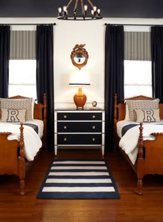 two twin beds in a bedroom with black and white decor