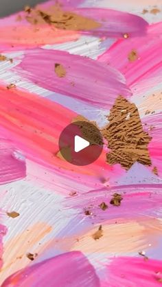 an abstract painting with pink and gold paint on the bottom half of it's face