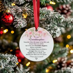 a christmas ornament hanging from the tree with a poem on it's side