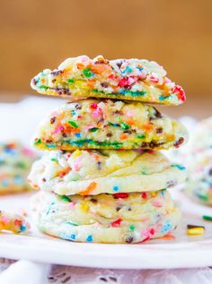 a stack of cookies with sprinkles and chocolate chips on top is shown