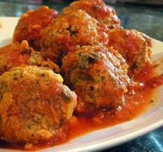 meatballs covered in marinara sauce on a plate