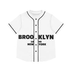 a white baseball jersey with black lettering on the front and back, that says brooklyn