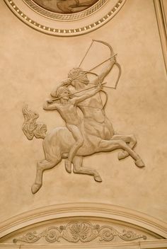 a statue of a man on a horse with a bow and arrow in his hand